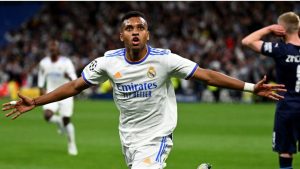 Rodrygo Goes, the Brazilian starlet at Real Madrid, has reportedly turned down a highly lucrative offer from Manchester City to remain at the Santiago Bernabéu. The decision showcases his loyalty and determination to cement his place within Carlo Ancelotti’s squad despite recent challenges.  Sources close to the negotiations suggest that Manchester City, led by Pep Guardiola, was preparing an enticing financial package to lure Rodrygo to the Etihad Stadium. The deal would have significantly increased his wages and offered him a starring role in City’s attacking setup. Yet, Rodrygo has chosen loyalty over financial gain.  Rodrygo’s commitment to Real Madrid comes at a time when his role in the team has been questioned, especially following the high-profile arrival of Kylian Mbappé. Mbappé’s presence has intensified competition in Madrid’s attacking line, with Rodrygo often finding himself overshadowed by the French superstar and other established players like Vinícius Júnior.  Despite these challenges, Rodrygo has remained steadfast in his desire to succeed in the iconic white shirt of Los Blancos. Reports indicate that he sought assurances from the Real Madrid hierarchy regarding his role and future at the club. While the specifics of those discussions remain undisclosed, it’s clear that Rodrygo’s ambition to thrive at Madrid played a pivotal role in his decision.  Manchester City’s interest in Rodrygo is hardly surprising. Guardiola has long admired the winger’s versatility, speed, and knack for delivering in crucial moments. City had identified him as a potential addition to bolster their attack, especially with their pursuit of Champions League glory in mind.  However, Real Madrid were unwilling to entertain offers for the 23-year-old. The club views Rodrygo as an integral part of their future, a player capable of carrying forward their attacking legacy. Florentino Pérez, the club president, is said to have personally intervened to ensure Rodrygo stays.  Rodrygo’s rejection of City’s offer also speaks volumes about his mindset. The winger, who has often been described as one of the most mentally resilient players of his generation, is determined to prove his worth on the biggest stage. His decision reflects his belief in his ability to shine at Real Madrid, despite the fierce competition for playing time.  This season, Rodrygo has had flashes of brilliance, reminding fans and critics alike of his immense talent. His memorable performances in crucial Champions League matches have solidified his reputation as a player for the big occasions. Yet, consistency has been an area for improvement, something he seems eager to address moving forward.  Rodrygo’s decision to stay at Real Madrid also highlights a broader trend in modern football, where loyalty and legacy occasionally triumph over financial incentives. In an era where player transfers are often dictated by lucrative contracts, Rodrygo’s choice serves as a refreshing reminder of the emotional connection some players have with their clubs.  The winger’s journey at Real Madrid has been anything but straightforward. From his breakout moments as a teenager to periods of struggle and criticism, Rodrygo has experienced the highs and lows of football. His decision to stay signals his readiness to embrace the challenges ahead and prove his mettle once again.  Real Madrid fans will undoubtedly welcome Rodrygo’s commitment, viewing it as a testament to the club’s enduring allure. The Bernabéu faithful have always valued players who show heart and determination, qualities Rodrygo continues to embody.  For Manchester City, missing out on Rodrygo might be a setback, but it underscores the challenges even the wealthiest clubs face when targeting players from elite institutions like Real Madrid.  As the January transfer window approaches, Rodrygo’s decision adds an intriguing layer to the ongoing narrative surrounding player movements. It’s a bold statement of intent, reaffirming his ambition to succeed at one of football’s most demanding clubs.  Rodrygo’s story at Real Madrid is far from over. With his unwavering determination and undeniable talent, the Brazilian is poised to write new chapters in the club’s illustrious history. Fans can only hope his loyalty will be rewarded with more trophies and memorable moments in the seasons to come.  In a world where big-money transfers dominate headlines, Rodrygo’s decision to stay at Real Madrid serves as a reminder of the value of perseverance and loyalty in football. It’s a move that could define his career and shape his legacy at the Bernabéu.